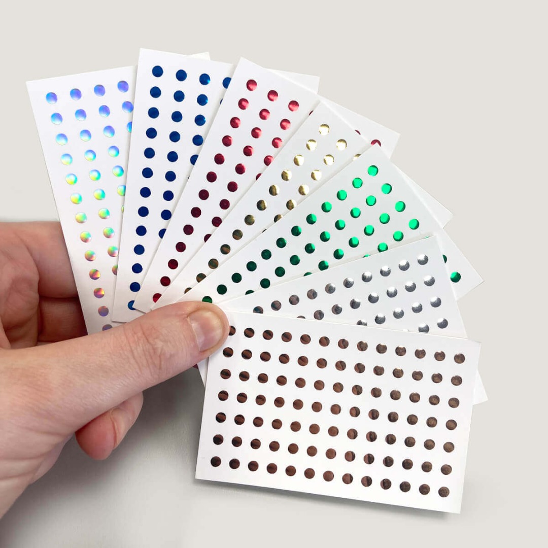 Business cards with different colours of foil applied in circles