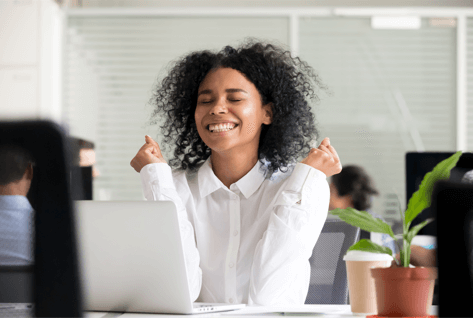 Woman cheering at her desk