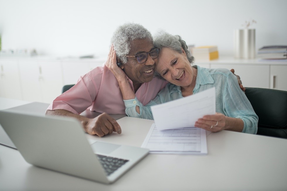 an elderly couple hugging in the workplace