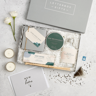 Grey letterbox sized gift box filled with new home presents