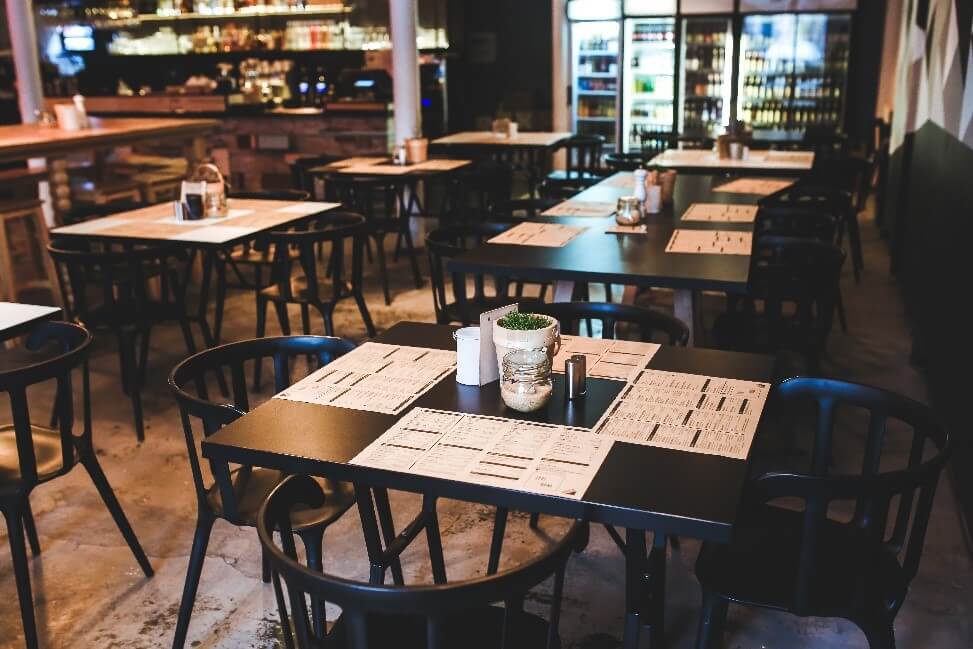 tables in a restaurant with menus being used as placemats