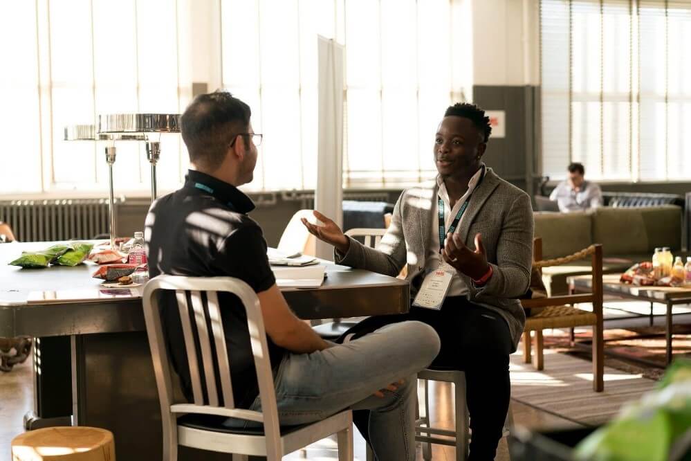 two men talking in an office