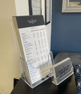 hair dresser price lists in a flyer holder on a counter top