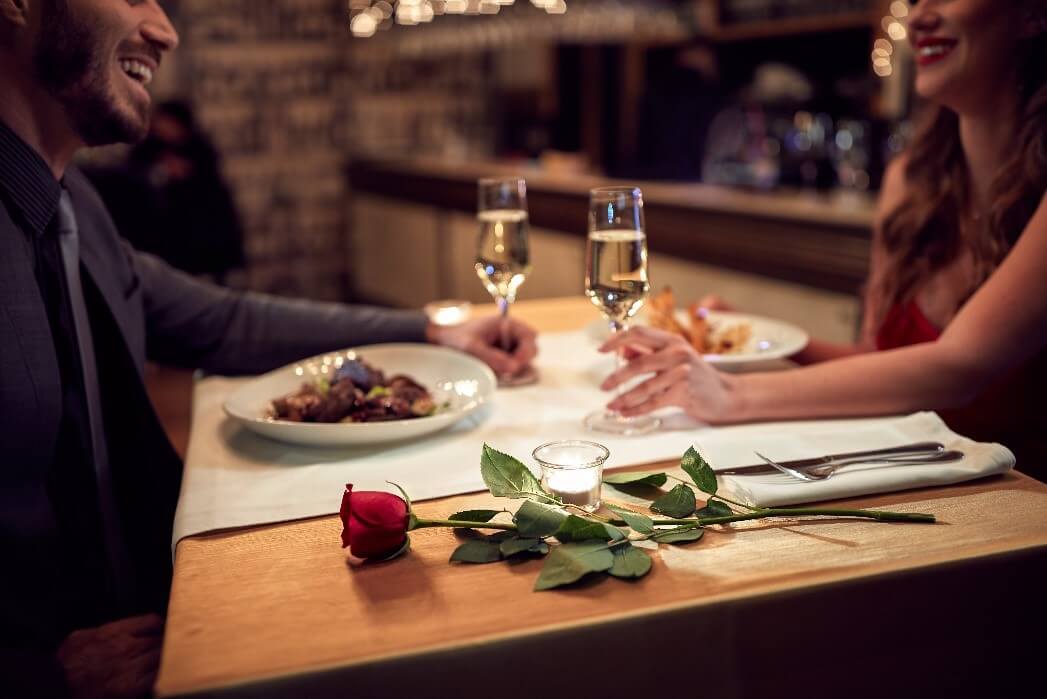 two people sat at a dinner table having a romantic date