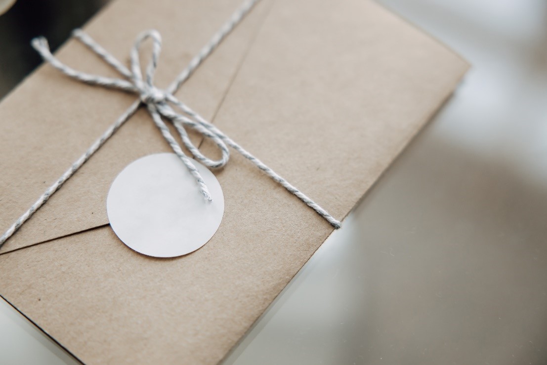 Brown Christmas card envelope sealed with a sticker