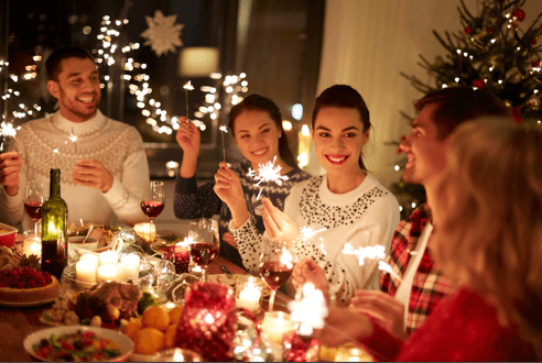 family with sparklers at a christmas dinner