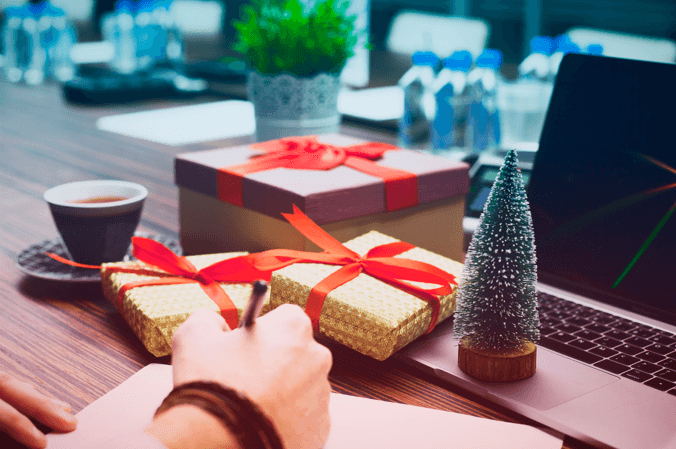 office desk with gold and red christmas presents