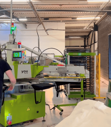 green commercial screen printer in a printing factory