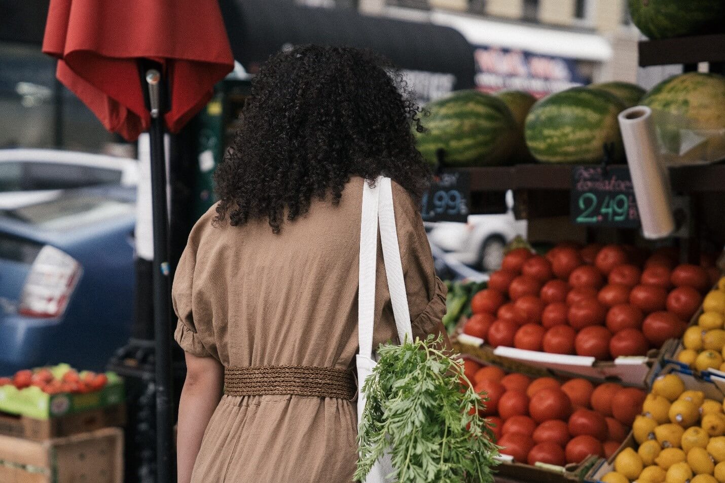 woman using a tote bag to hold vegetables