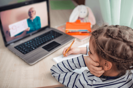 school girl using a laptop for an maths lesson with an online tutor