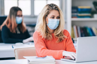 Female Covid 19 Employee wearing a mask