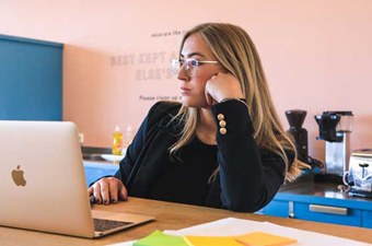 Woman in the office looking bored