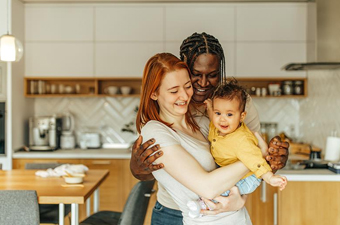 Happy family smiling at child