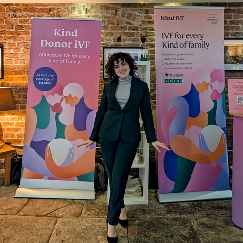 Victoria Thomas of London Women’s Clinic standing between two of the clinic’s roller banners