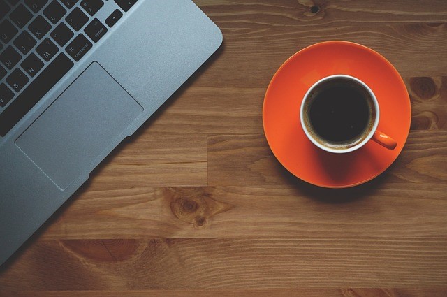 desk with coffee and laptop