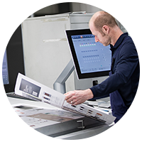 Print technician inspecting print