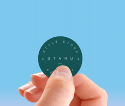 Dark green small sticker with logo on held with hand