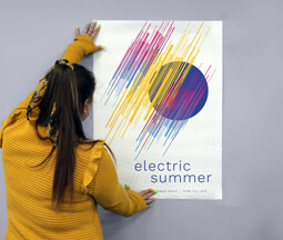 Person holding an A1 Poster adveritising a summer festival