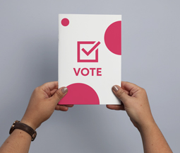 female holding campaign stapled booklet