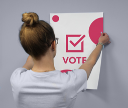 Women holding a white electoral Poster