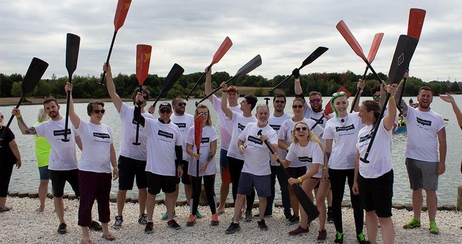 team instantsink hold their oars in the air in celebration