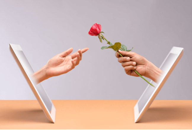hands offering a rose through a tablet