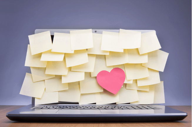 post it notes and a heart on a laptop