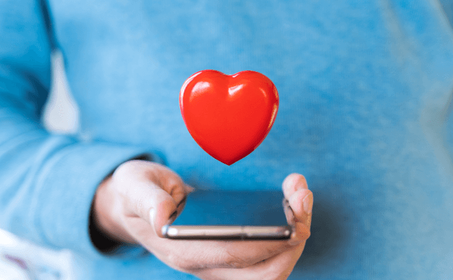 red heart coming out of a mobile phone