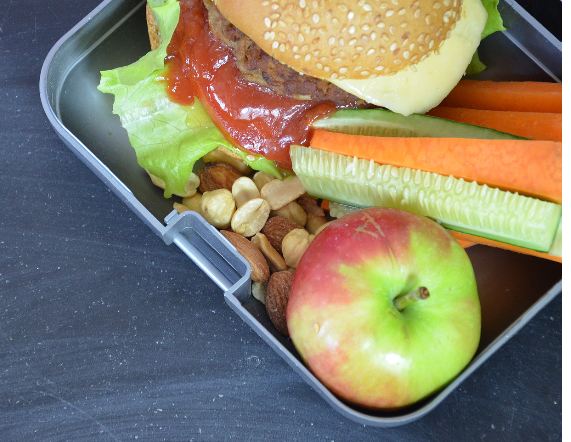 lunch box with sandwich, nuts and vegetables