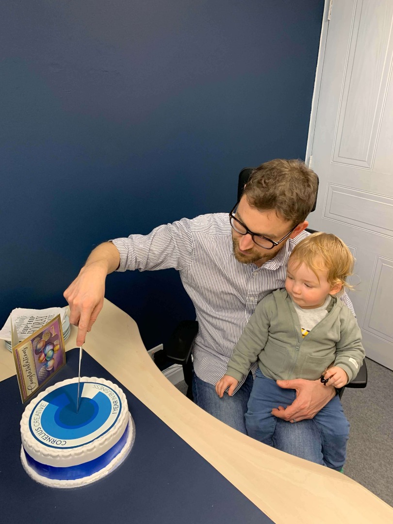 Simon and son Leo celebrating a year of business with cake