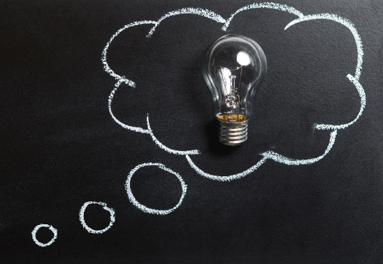 white chalk lightbulb on a blackboard