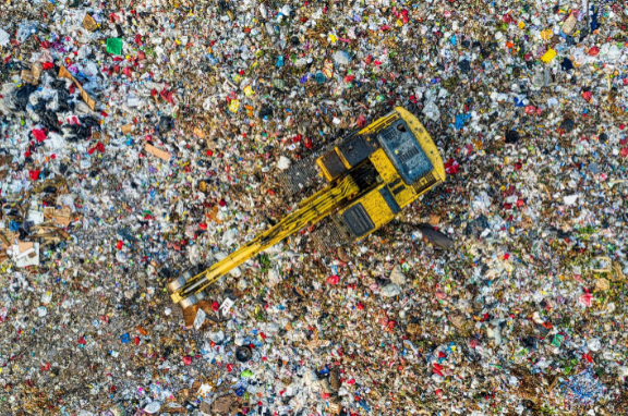 A pile of e-waste with a crane