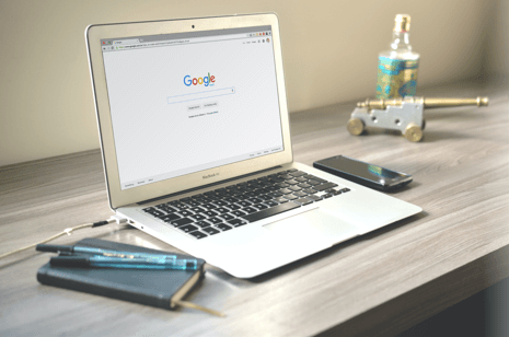 google search on a laptop on a desk