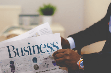 business man holding a newspaper