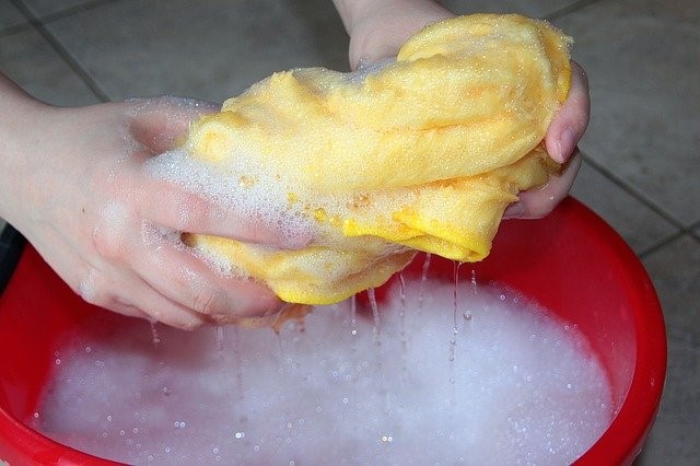 red bucket with sponge and soapy water